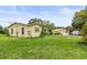 Charming yellow home with a well-maintained lawn and separate garage, creating a welcoming curb appeal at 5981 Jim Davis Rd, Parrish, FL 34219