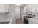 Updated kitchen featuring white cabinets, stainless steel appliances, granite countertops, and tile backsplash at 5981 Jim Davis Rd, Parrish, FL 34219