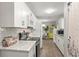 Open kitchen with stainless steel appliances, white cabinetry, and an adjacent dining area at 5981 Jim Davis Rd, Parrish, FL 34219