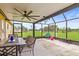 Enjoy this lovely outdoor patio with ceiling fan and views of the expansive green fields surrounding the property at 5981 Jim Davis Rd, Parrish, FL 34219