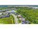 An aerial view showcases the community layout, featuring homes with lush green surroundings at 6306 Anise Dr, Sarasota, FL 34238