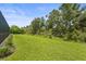 Sprawling lush backyard with grass and mature trees, perfect for outdoor activities at 6306 Anise Dr, Sarasota, FL 34238
