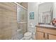 Bathroom featuring glass enclosed shower, decorative tile, vanity with framed mirror and fixtures at 6306 Anise Dr, Sarasota, FL 34238