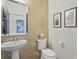 Modern half bathroom with designer wallpaper and a pedestal sink at 6306 Anise Dr, Sarasota, FL 34238