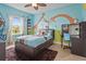 bedroom featuring colorful themed wall art, window for natural light and ceiling fan at 6306 Anise Dr, Sarasota, FL 34238