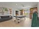 This expansive bonus room is equipped with an air hockey table, sofa, and a built-in slide at 6306 Anise Dr, Sarasota, FL 34238