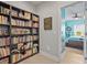 Book room featuring a wall of shelving and an open doorway to a bedroom with themed wall art at 6306 Anise Dr, Sarasota, FL 34238