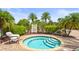 A community spa with steps, railings, and lounge chairs with a clear sky in the background at 6306 Anise Dr, Sarasota, FL 34238