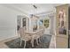 Bright dining room with an elegant table set, white wainscotting, and a cabinet for storage at 6306 Anise Dr, Sarasota, FL 34238