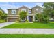 Inviting two-story home featuring a well-kept lawn and charming landscaping at 6306 Anise Dr, Sarasota, FL 34238