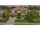 Beautiful two-story home with a well-manicured lawn and mature landscaping at 6306 Anise Dr, Sarasota, FL 34238