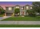 Inviting two-story home featuring a well-kept lawn and charming landscaping at 6306 Anise Dr, Sarasota, FL 34238