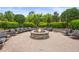 A community fire pit with chairs surrounding it and trees in the background at 6306 Anise Dr, Sarasota, FL 34238