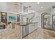 Bright kitchen with an island, stainless steel appliances, and a modern lighting fixture at 6306 Anise Dr, Sarasota, FL 34238