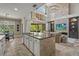Open-concept kitchen features a large island, granite countertops, and a stone accent wall with a fireplace at 6306 Anise Dr, Sarasota, FL 34238