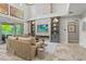 Bright living area featuring a stone fireplace, built-in shelving, and backyard views at 6306 Anise Dr, Sarasota, FL 34238