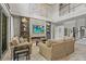 Open living space showcasing a stone fireplace, tall windows, and comfortable seating at 6306 Anise Dr, Sarasota, FL 34238