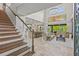 Open-concept living area boasts high ceilings, staircase, and travertine flooring at 6306 Anise Dr, Sarasota, FL 34238