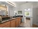 This main bathroom has granite countertops, dual sinks, and overlooks the main bedroom at 6306 Anise Dr, Sarasota, FL 34238