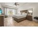 This spacious main bedroom has tile floors, a tray ceiling, and a large window for natural light at 6306 Anise Dr, Sarasota, FL 34238