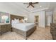 This main bedroom has tile floors, a ceiling fan, and overlooks the main bathroom at 6306 Anise Dr, Sarasota, FL 34238