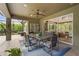 Covered patio features an outdoor dining table and overlooks the landscaped backyard at 6306 Anise Dr, Sarasota, FL 34238