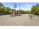 Community playground with wooden play structures and a spring rider for active fun at 6306 Anise Dr, Sarasota, FL 34238