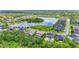 A picturesque pond view is featured with homes nestled around the water in this aerial shot at 6306 Anise Dr, Sarasota, FL 34238