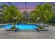 A luxurious, screened-in swimming pool is highlighted with palm trees and tile water features at 6306 Anise Dr, Sarasota, FL 34238