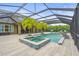 Enclosed pool area with a hot tub, lush palm trees, and outdoor lounge chairs at 6306 Anise Dr, Sarasota, FL 34238