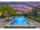 Backyard oasis with an enclosed pool and spa area, perfect for relaxation and entertainment at 6306 Anise Dr, Sarasota, FL 34238