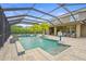 Luxurious screened pool features a hot tub, palm trees and open deck space at 6306 Anise Dr, Sarasota, FL 34238
