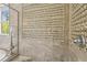 The shower is lined with elegant neutral-colored tiles and features built-in shelving at 6306 Anise Dr, Sarasota, FL 34238