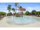 A community splash pad with playground equipment and lounge chairs surrounding it at 6306 Anise Dr, Sarasota, FL 34238