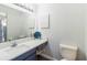 Well-lit bathroom with modern vanity, toilet, and decorative mirror at 643 Park Cir, Bradenton, FL 34207