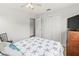 Neutral bedroom with closet, neutral bedding, and a TV on dresser at 643 Park Cir, Bradenton, FL 34207