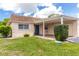 Charming single-story home featuring a well-maintained lawn, cozy carport, and inviting blue front door at 643 Park Cir, Bradenton, FL 34207