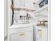 Functional laundry room equipped with a washer, dryer, water heater, and shelving at 643 Park Cir, Bradenton, FL 34207