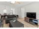 Open living area with dining, featuring sleek TV console, and wood-look floors at 643 Park Cir, Bradenton, FL 34207
