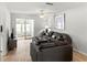 Bright living room with wood floors, neutral walls, modern decor, and sliding glass doors to outside at 643 Park Cir, Bradenton, FL 34207