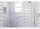 Modern shower features sleek white subway tile and a built-in toiletry niche at 643 Park Cir, Bradenton, FL 34207