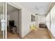 Bright sunroom with wood floors, ceiling fan, chairs, and an adjacent room with television at 643 Park Cir, Bradenton, FL 34207