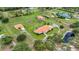 Aerial view of an estate with a large pond, expansive green spaces, and a horse paddock at 7025 Saddle Creek Cir, Sarasota, FL 34241