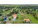 Vast aerial view of a home and property featuring multiple structures, a pond, and greenery at 7025 Saddle Creek Cir, Sarasota, FL 34241