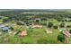 Expansive aerial view of a large estate featuring lush greenery, well-maintained lawns, and a horse paddock at 7025 Saddle Creek Cir, Sarasota, FL 34241