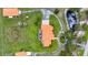Overhead view of home with orange roof with circular drive, horse paddock and pond at 7025 Saddle Creek Cir, Sarasota, FL 34241