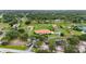 Expansive aerial view of property with lush landscaping, a pond, and multiple residences at 7025 Saddle Creek Cir, Sarasota, FL 34241