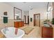 Beautiful primary bathroom features dual vanities, a soaking tub, tile floors, and separate vanities at 7025 Saddle Creek Cir, Sarasota, FL 34241