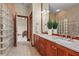 Bathroom with double sink vanity, granite countertops, and glass block window for natural lighting at 7025 Saddle Creek Cir, Sarasota, FL 34241