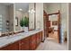 Bathroom with double sink vanity, granite countertop and glass block window at 7025 Saddle Creek Cir, Sarasota, FL 34241